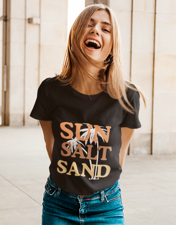 Women Model wearing the Sun Salt Sand Printed Black T-Shirt, paired with jeans for a casual summer look.