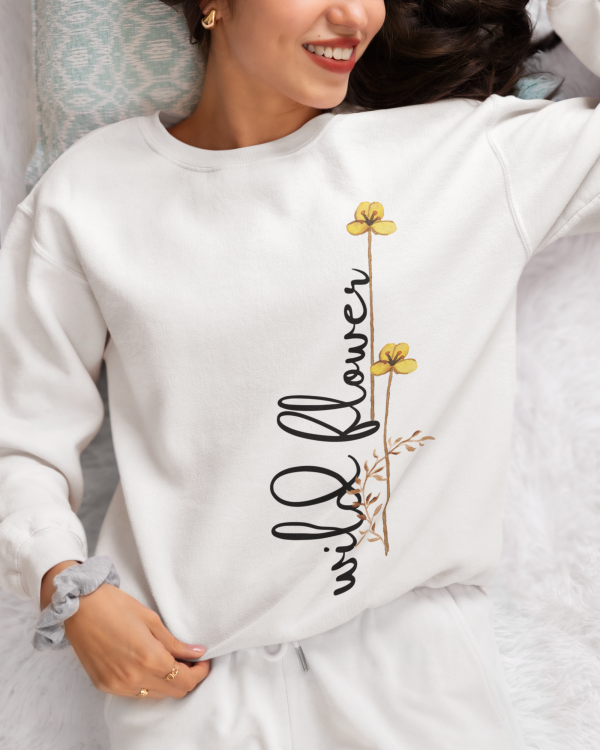 Close-up of the intricate wild flower print on a white sweatshirt, highlighting premium cotton fabric.