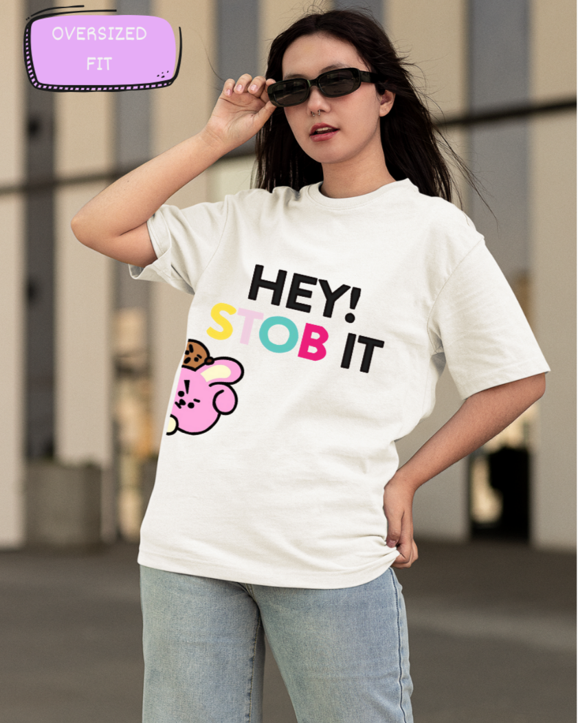 Female Model wearing the 'Hey Stob It' printed White oversize t-shirt paired with jeans for a casual look.

