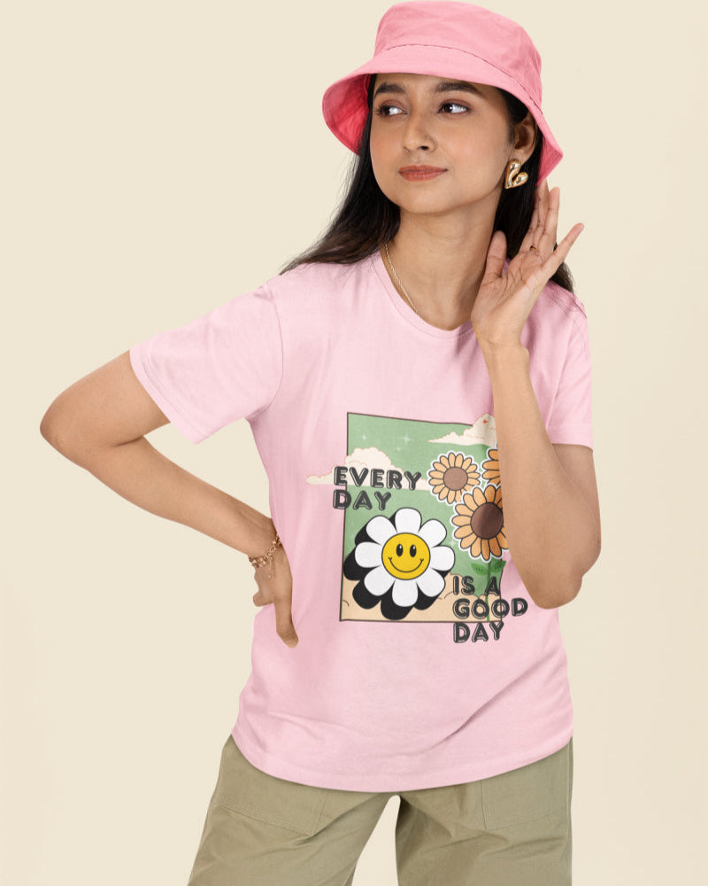 Model wearing the 'Every Day is a Good Day' printed light pink T-shirt paired with jeans for a casual look.
