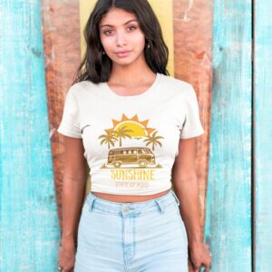 hispanic girl wearing a tshirt mockup standing against a surfboard a18806