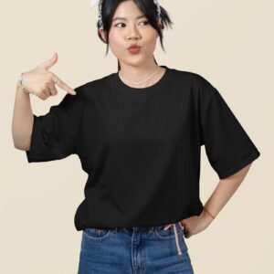 oversized mockup featuring a woman pointing at her round neck t shirt in a studio m51459 1 1