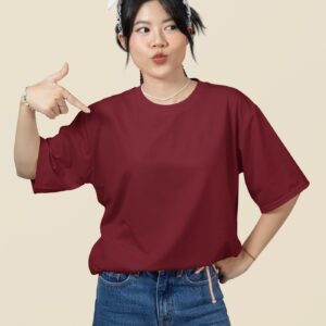 oversized mockup featuring a woman pointing at her round neck t shirt in a studio m51459 6